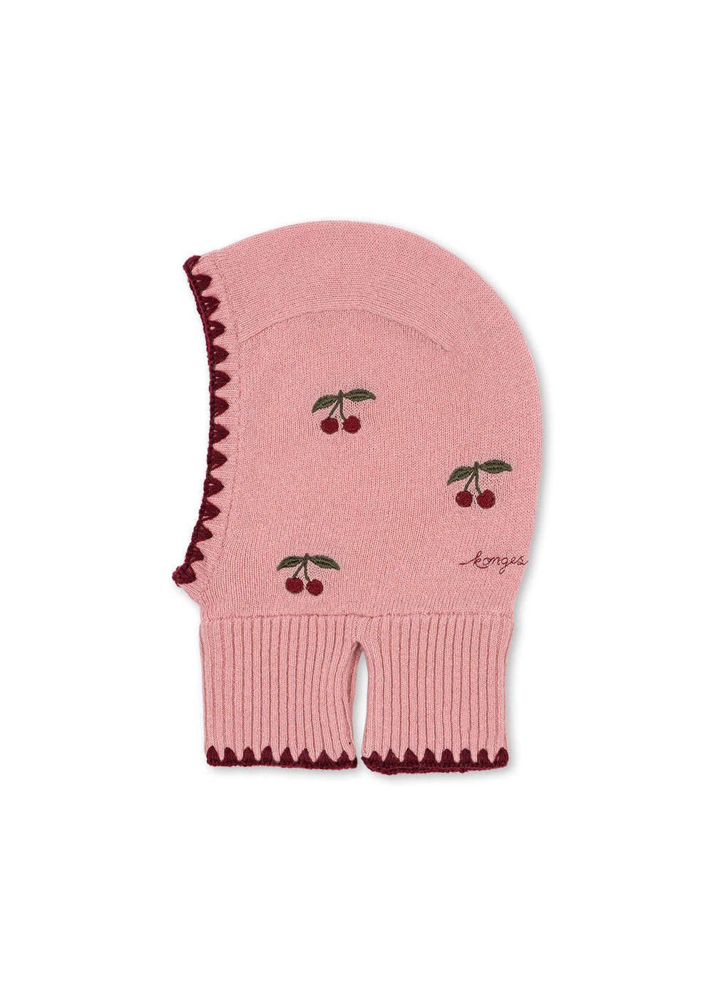 Cagoule en laine Collette – Pale Blush – Konges Sløjd : cagoule en tricot rose avec cerises et liseré sombre, vue de profil.